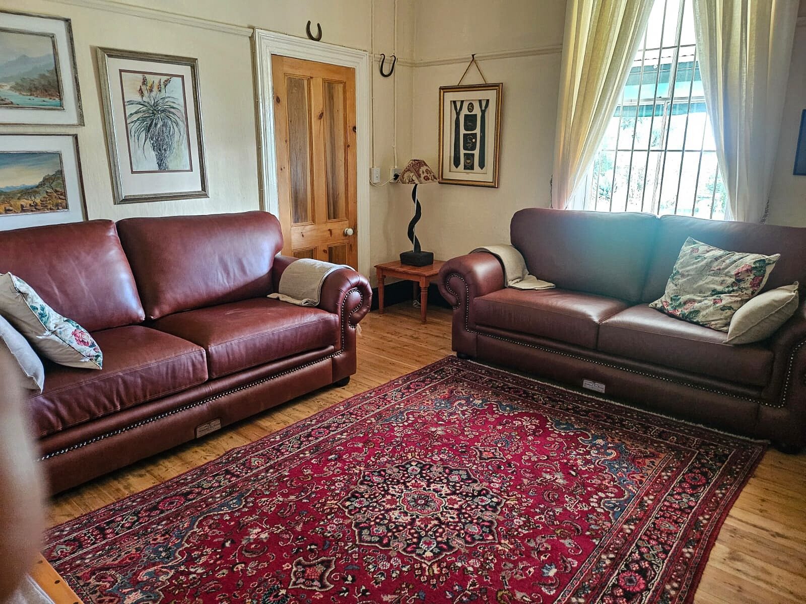 The lodge lounge with leather sofas and a Persian rug