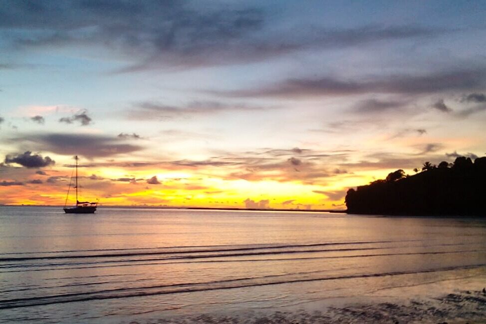 Sunset over an anchored yacht off Nosy Be