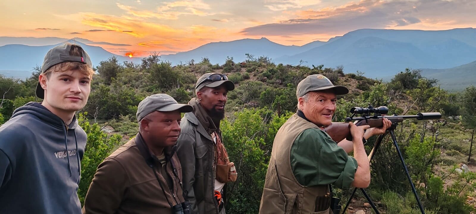 Guide, trackers and hunter at last light