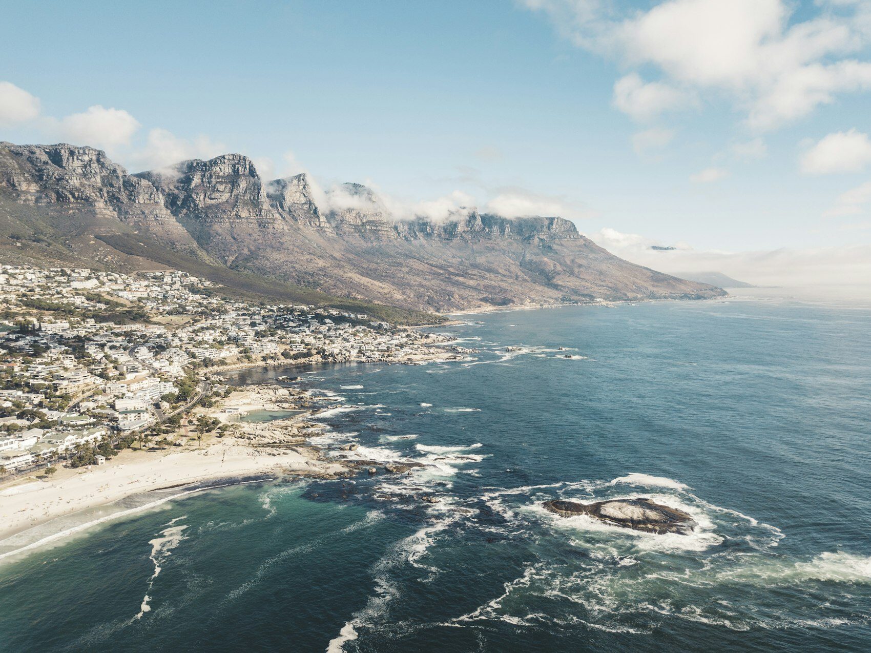 Mountains dropping to a curved bay on the South African coast