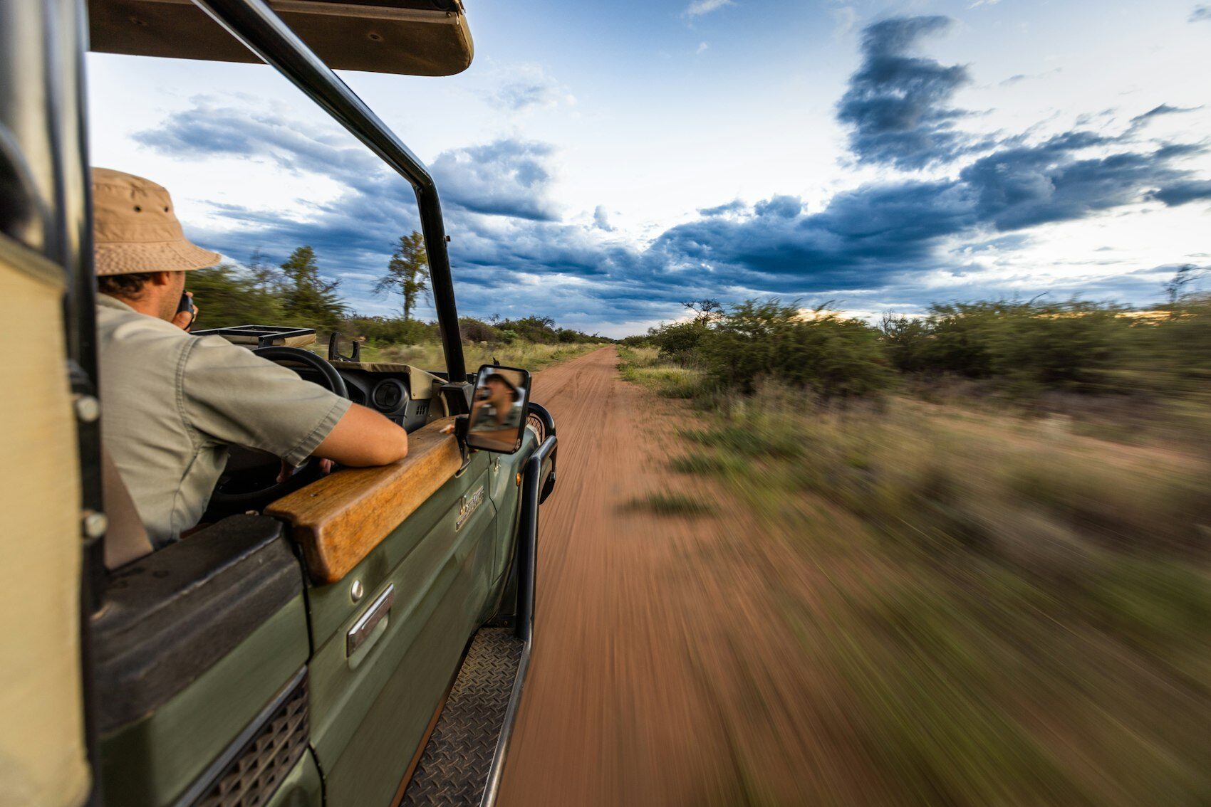 A guide driving a game viewer along a bush track