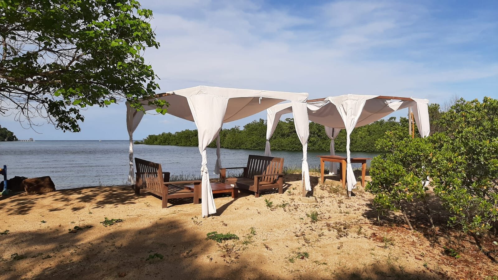 A beach deck with cabanas overlooking the mangroves on Nosy Be