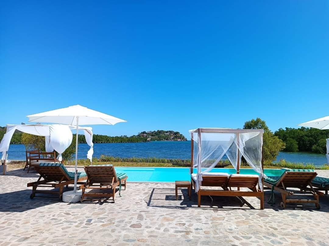 A swimming pool with loungers and a cabana on Nosy Be