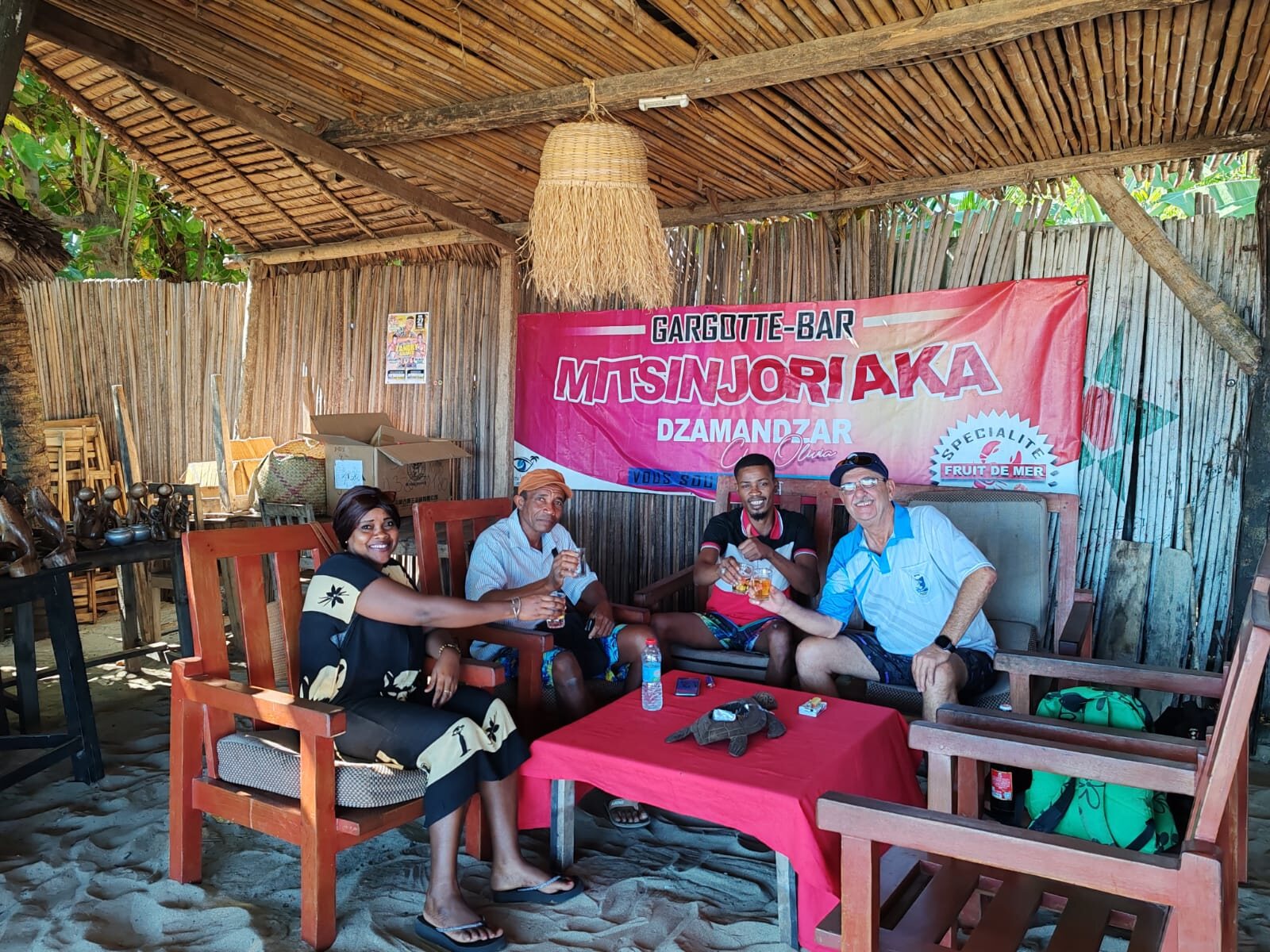 Guests sharing a meal at a beach bar on Nosy Be