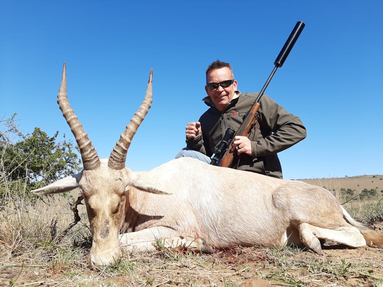 A hunter with a white blesbok trophy
