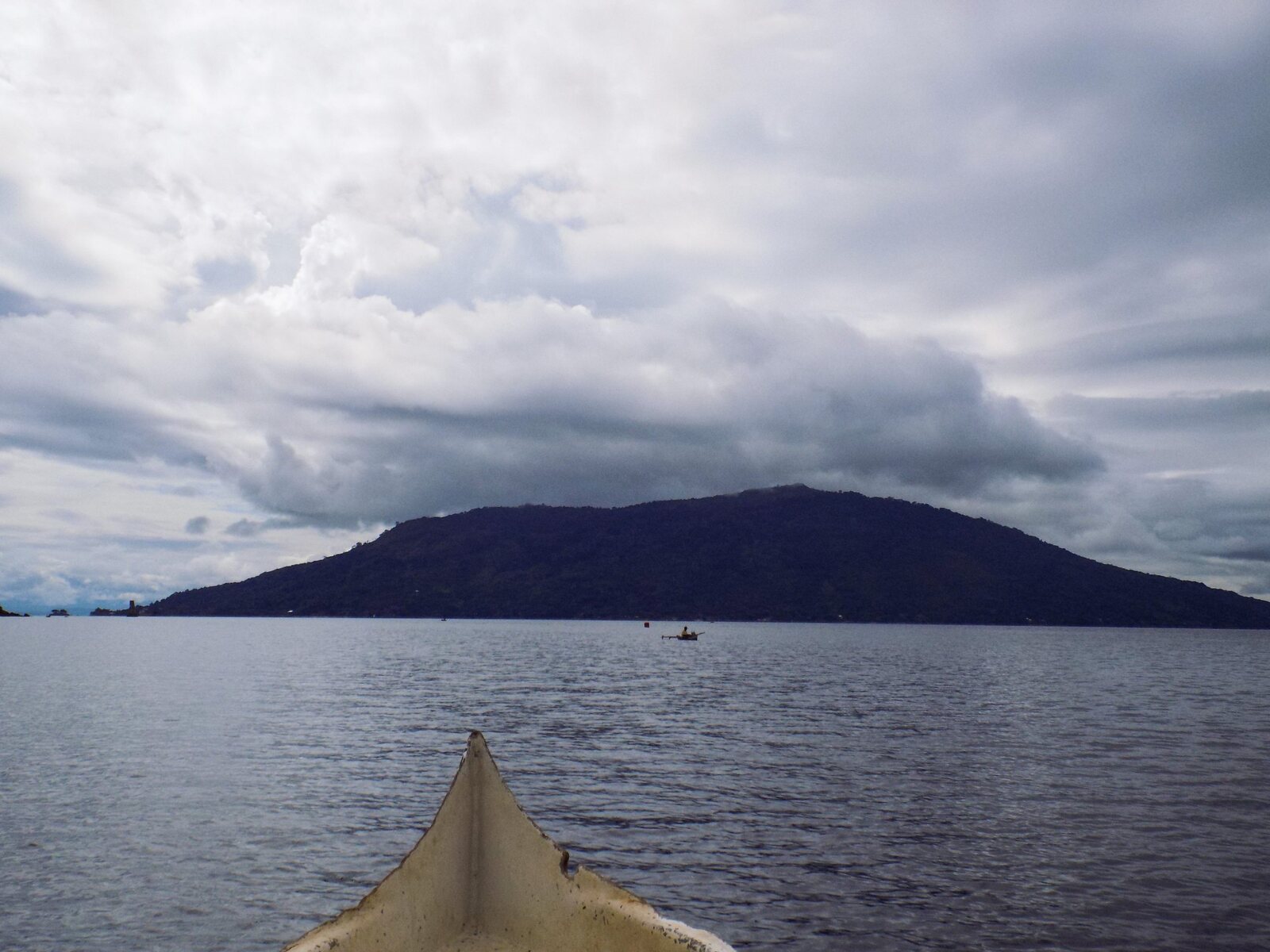 An island seen from the bow of a boat off Nosy Be