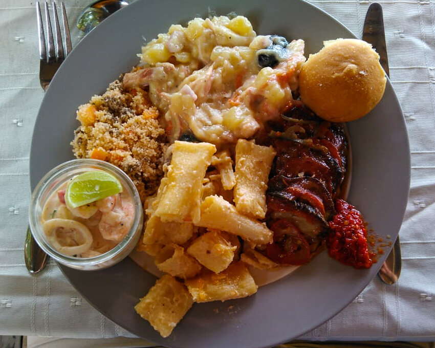 A plate of seafood with calamari and grilled meat on Nosy Be