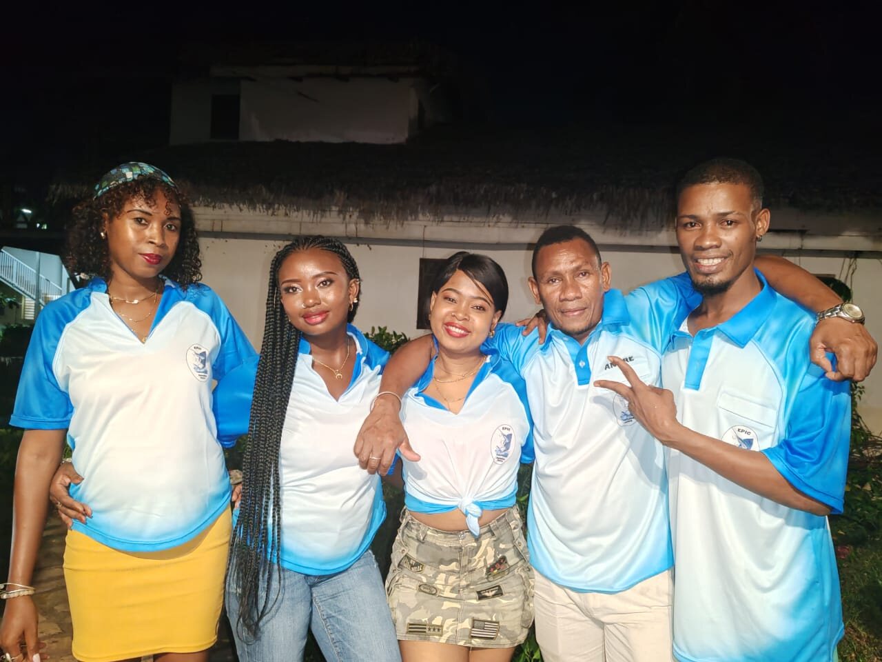 A group of smiling young people on Nosy Be at night