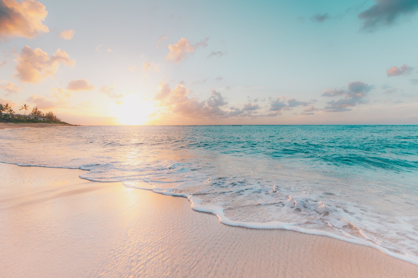 The sun setting over a tropical beach