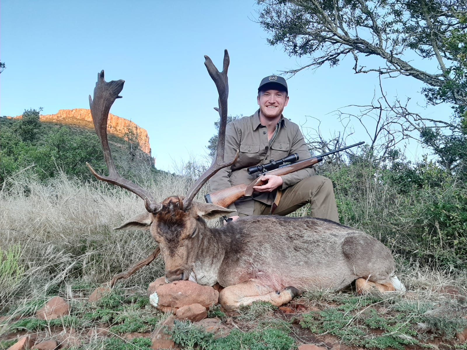 A hunter with a fallow deer trophy