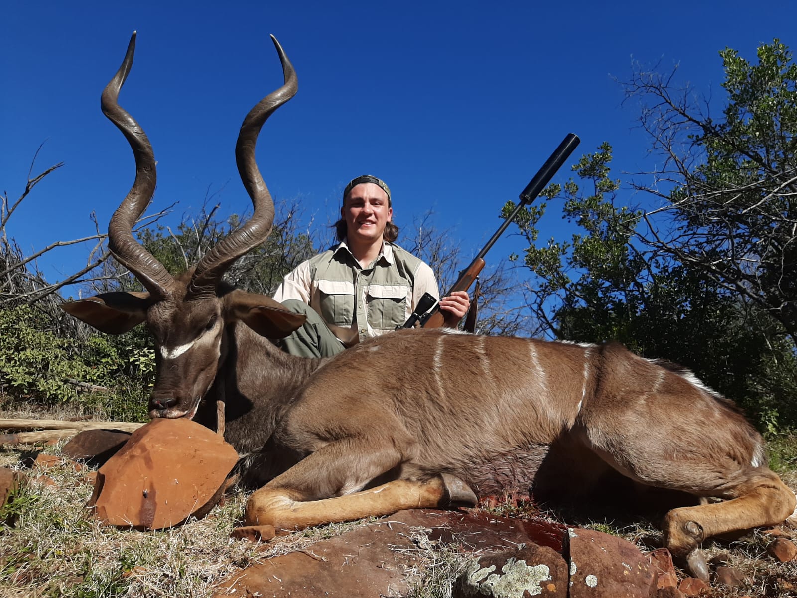 A hunter with a kudu bull taken in South Africa