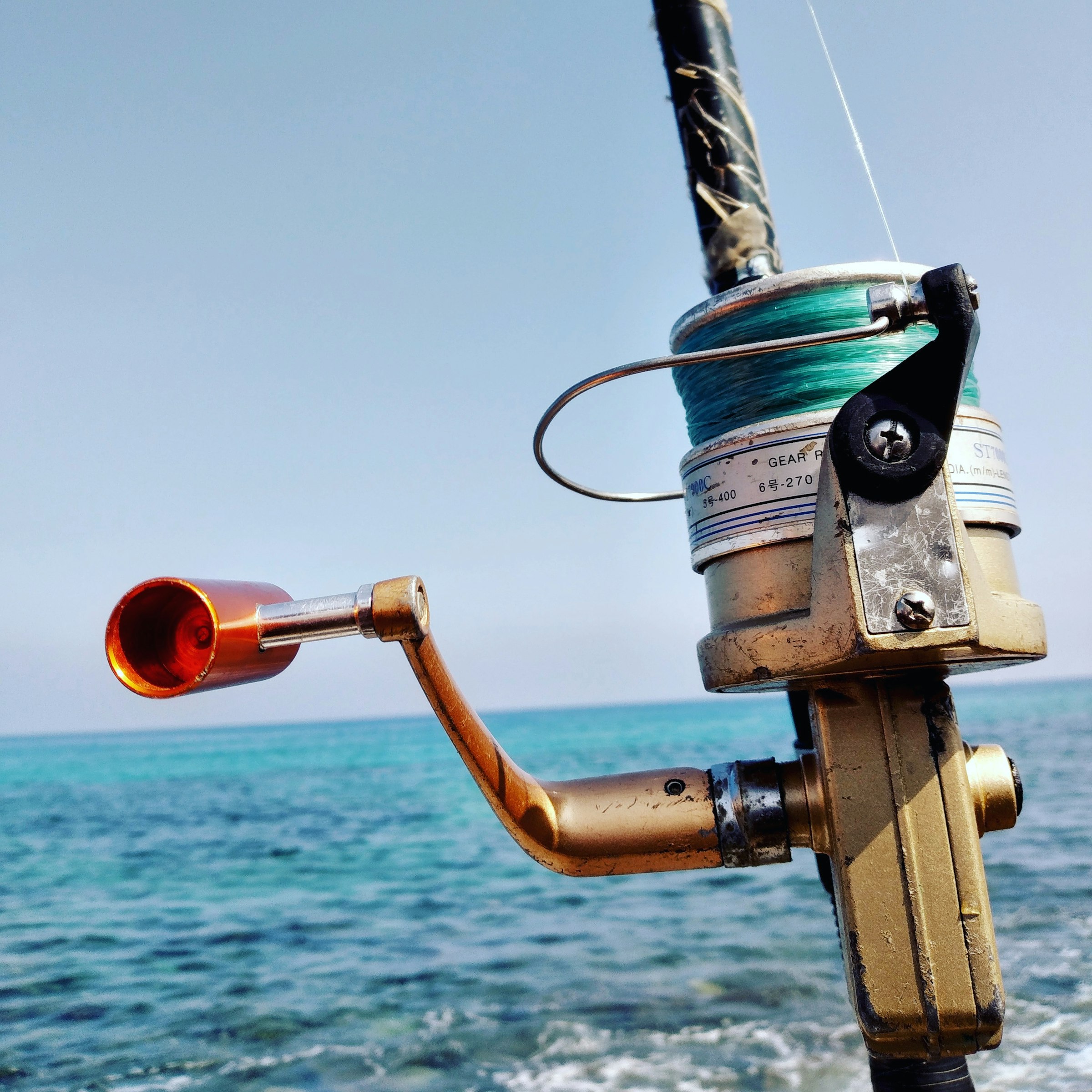 A spinning reel ready over the shallows