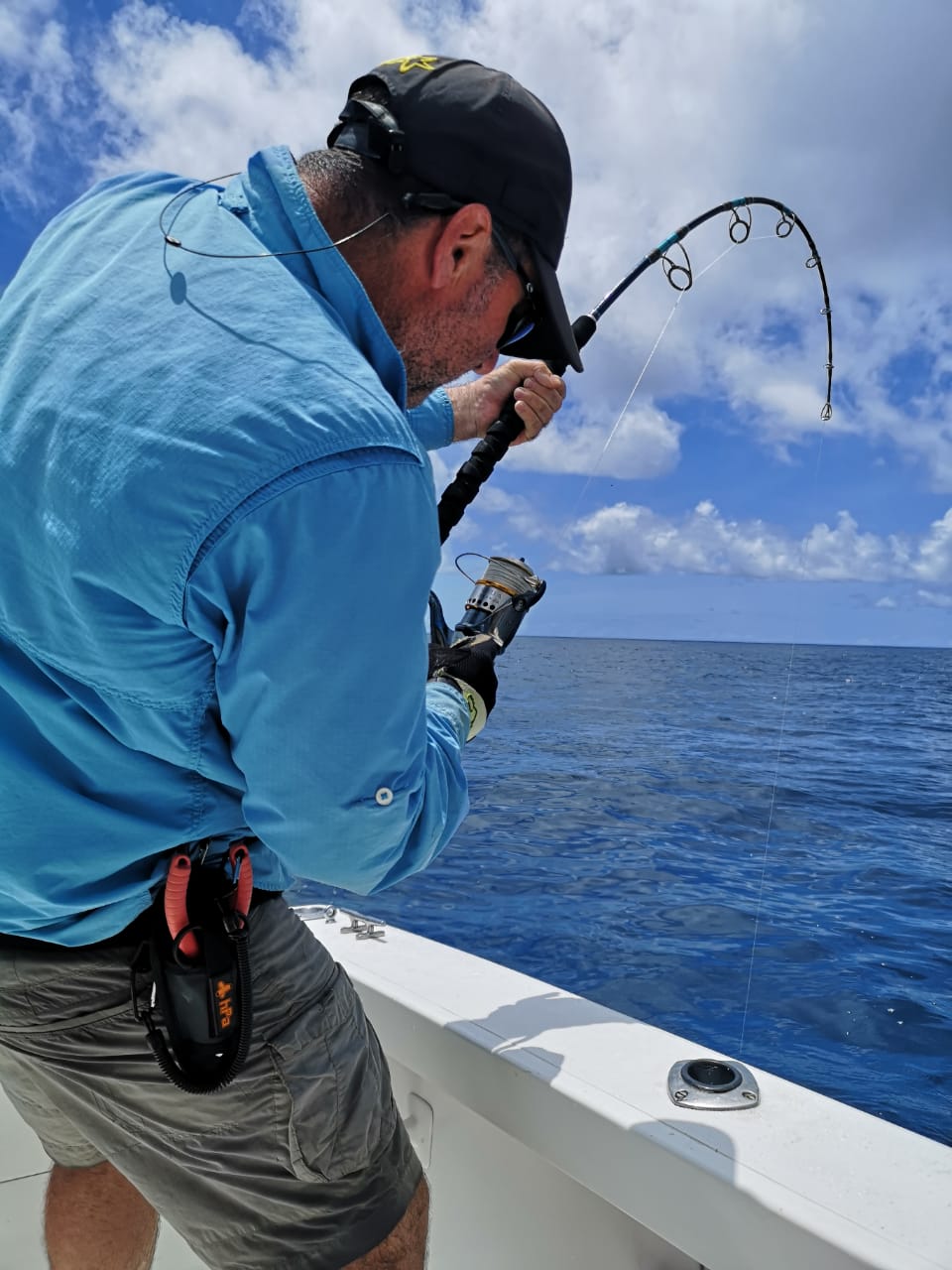 An angler working a jig on a bent rod